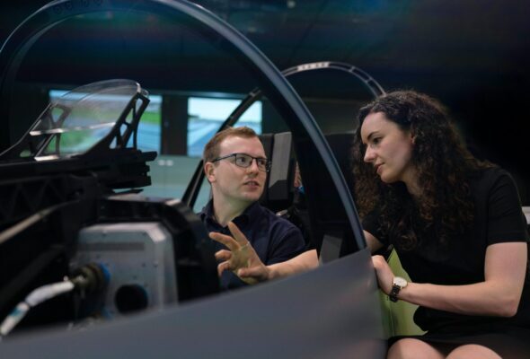 Engineers analyzing aircraft cockpit design during a simulation session.